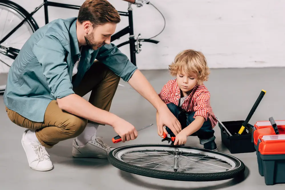 father with a child fixing a tire